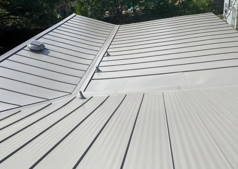 Solar attic fan installed on a metal roof for Roof Ventilation in Ypsilanti